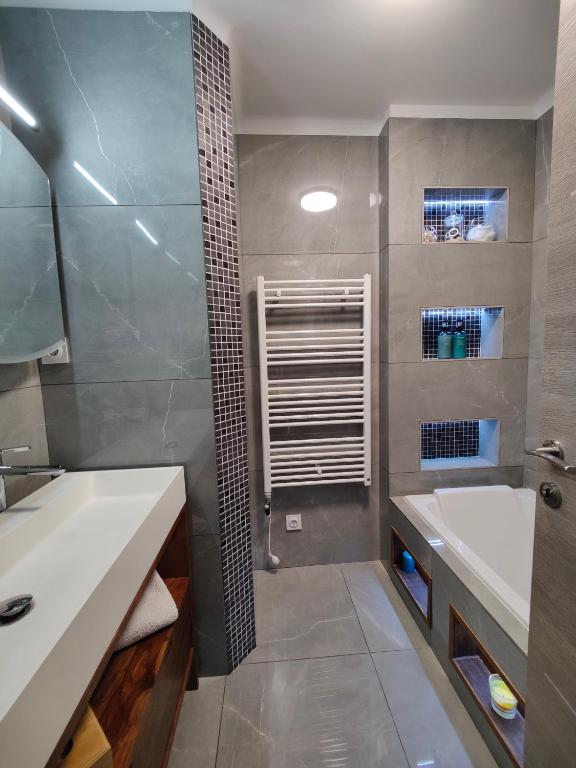 Modern bathroom with a cozy bathub and shower